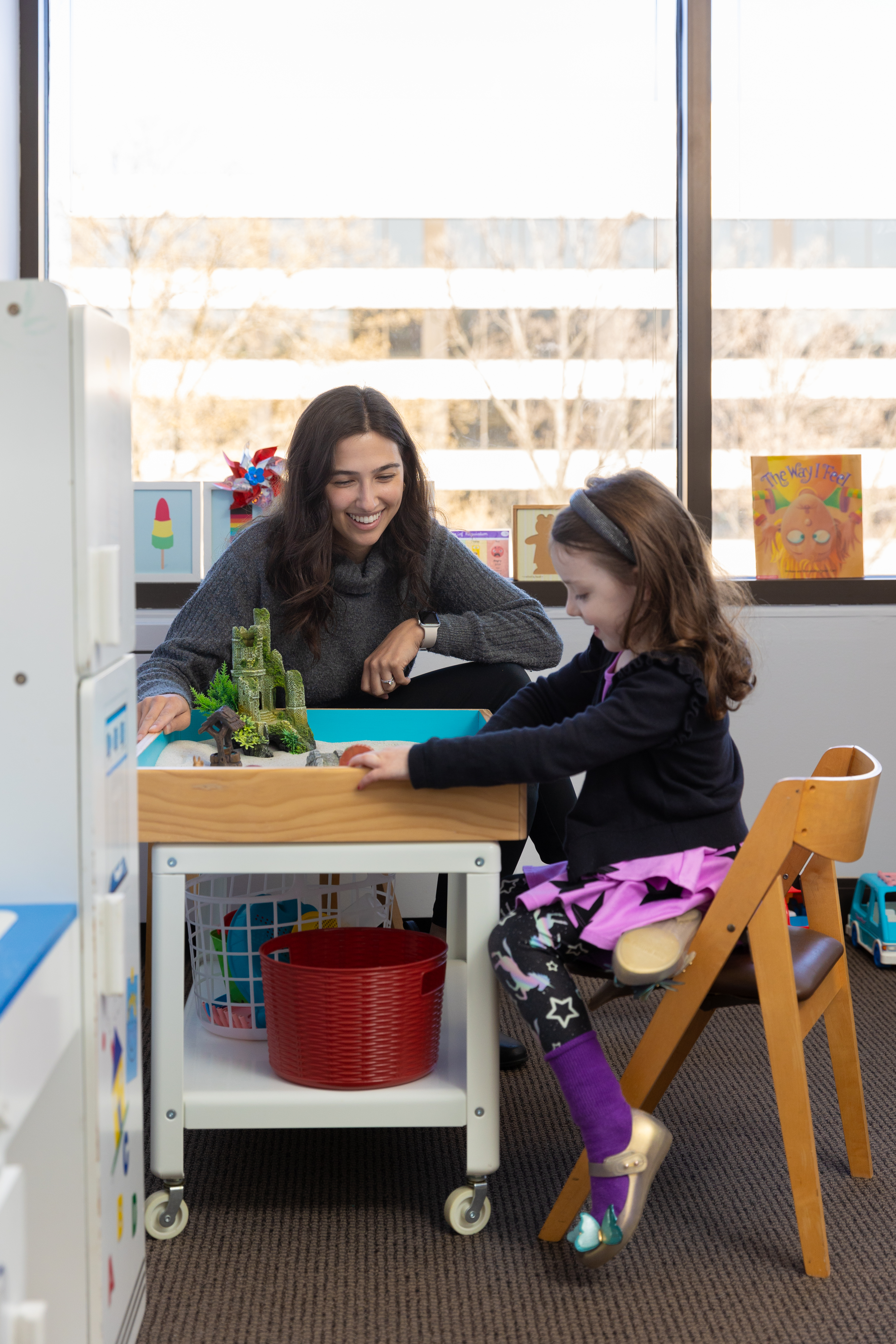 Therapist playing with a child during a session